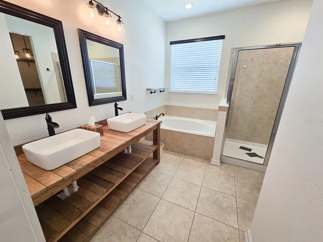 a bathroom with a sink a mirror and a bathtub