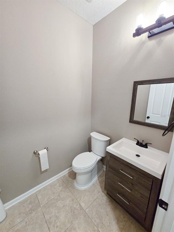 3543 Meadow Breeze Loop Ocoee, FL 34761 - Photo 24 of 38 a bathroom with a toilet sink and mirror