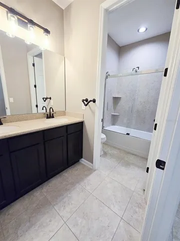 a bathroom with a sink a mirror and a bathtub