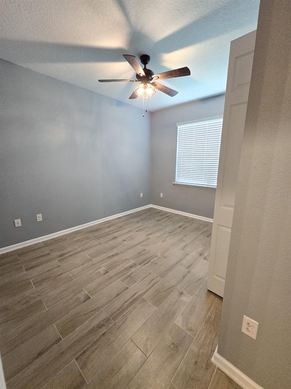 3543 Meadow Breeze Loop Ocoee, FL 34761 - Photo 28 of 38 an empty room with a ceiling fan and a window