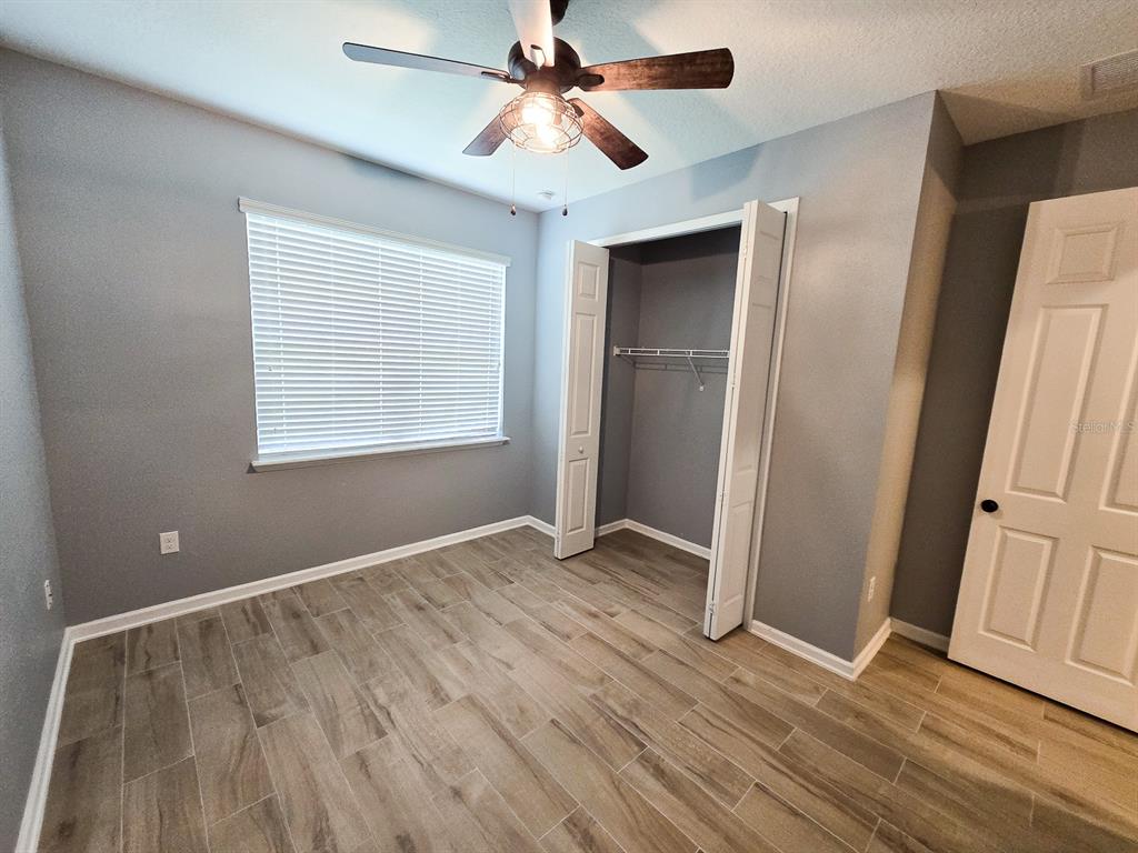 3543 Meadow Breeze Loop Ocoee, FL 34761 - Photo 29 of 38 wooden floor in an empty room with a window