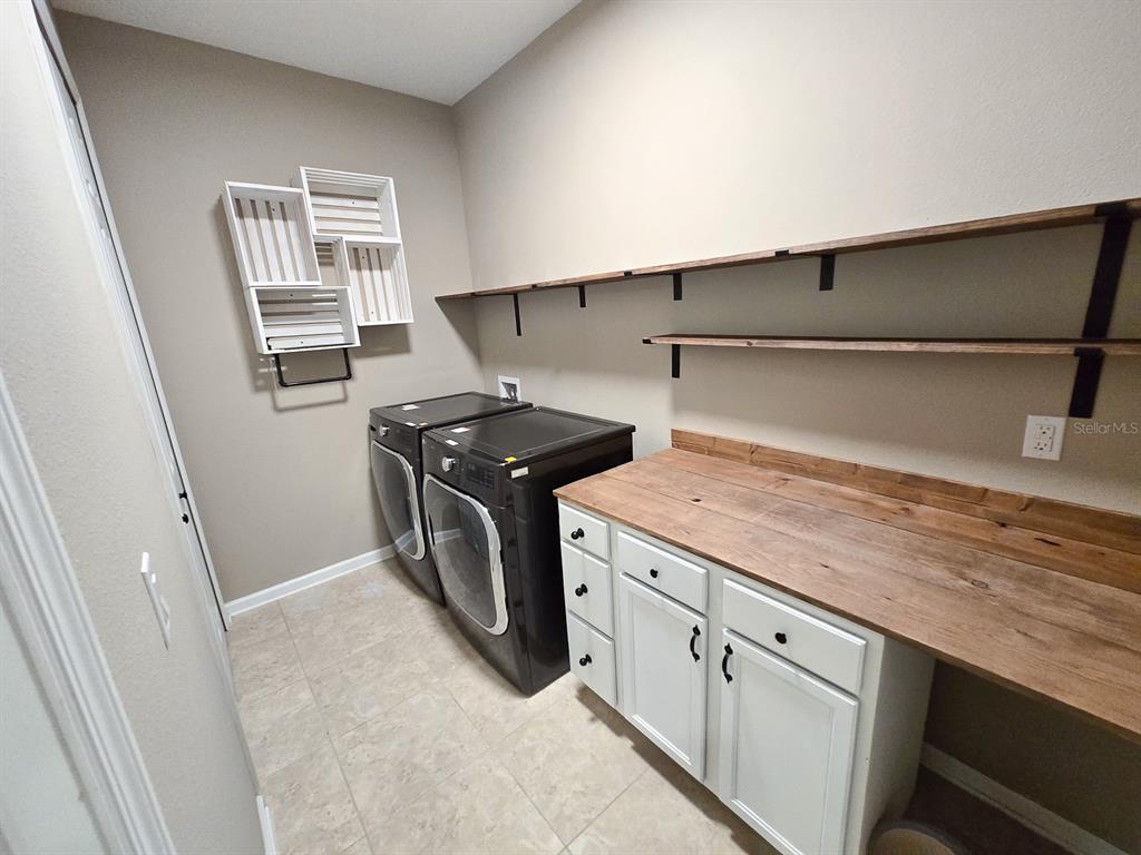 3543 Meadow Breeze Loop Ocoee, FL 34761 - Photo 32 of 38 a utility room with cabinets washer and dryer