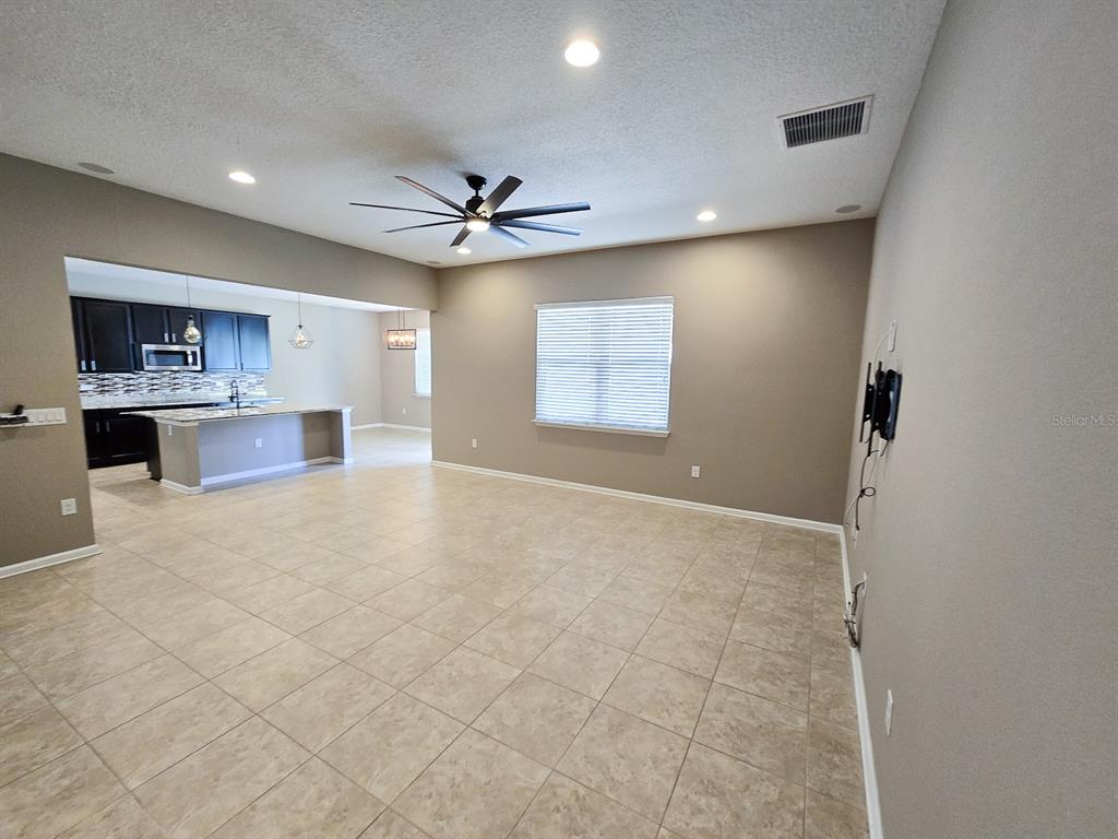 3543 Meadow Breeze Loop Ocoee, FL 34761 - Photo 4 of 38 a view of a kitchen with a sink and a stove
