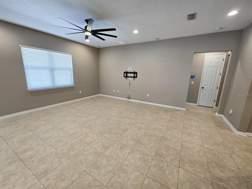 3543 Meadow Breeze Loop Ocoee, FL 34761 - Photo 5 of 38 an empty room with windows and fan