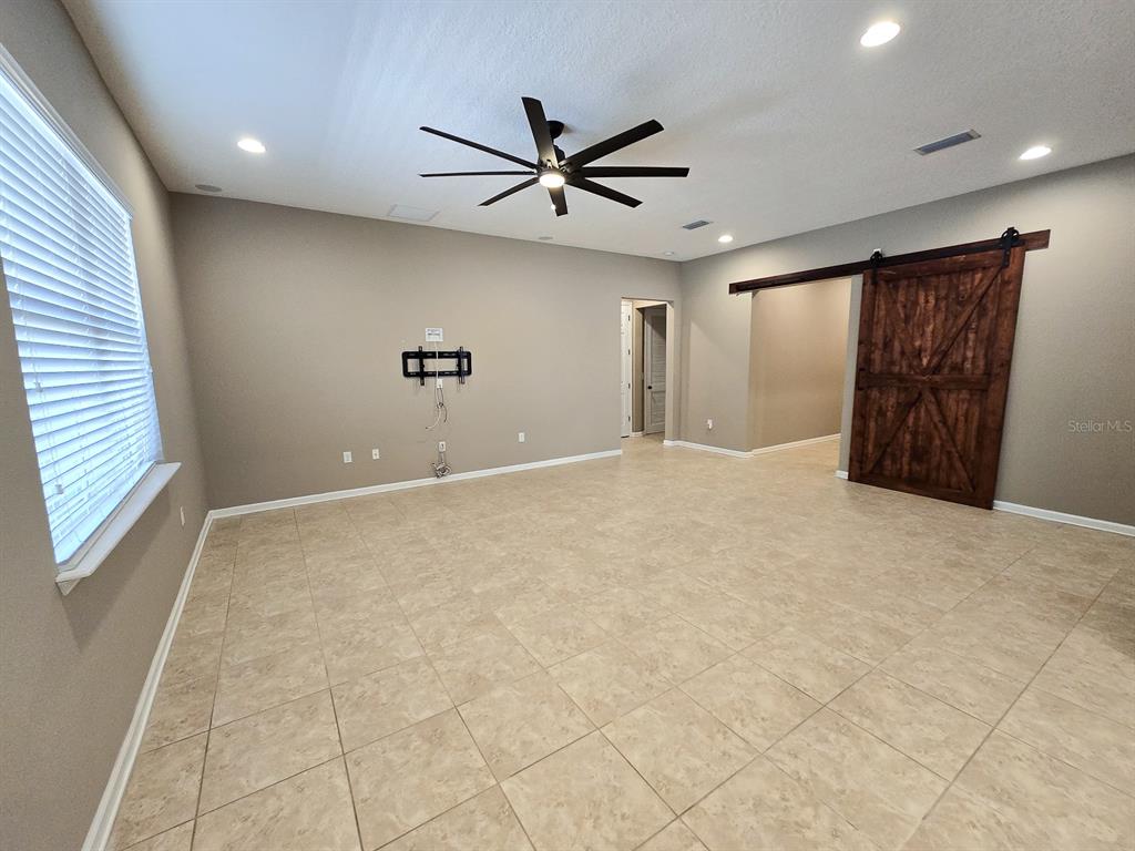 3543 Meadow Breeze Loop Ocoee, FL 34761 - Photo 6 of 38 a view of an empty room with a window
