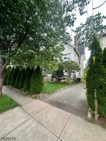 a view of a street with trees on both side of it