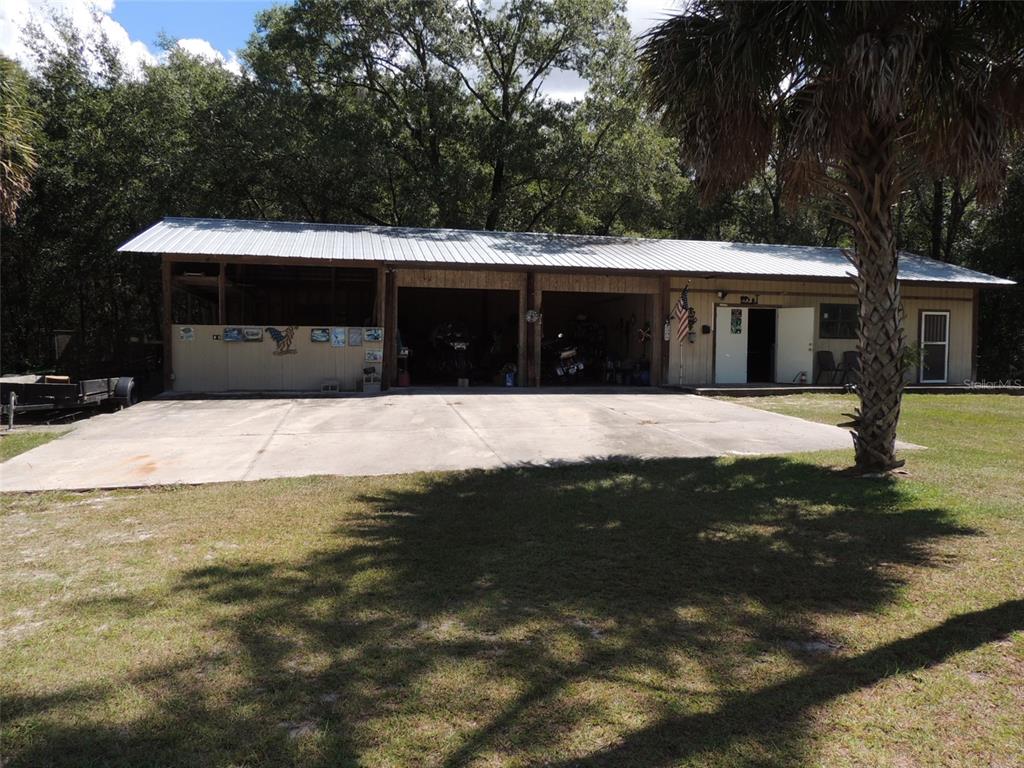 7050 Southeast Co Road 337 Morriston, FL 32668 - Photo 14 of 67 a swimming pool with outdoor seating and yard