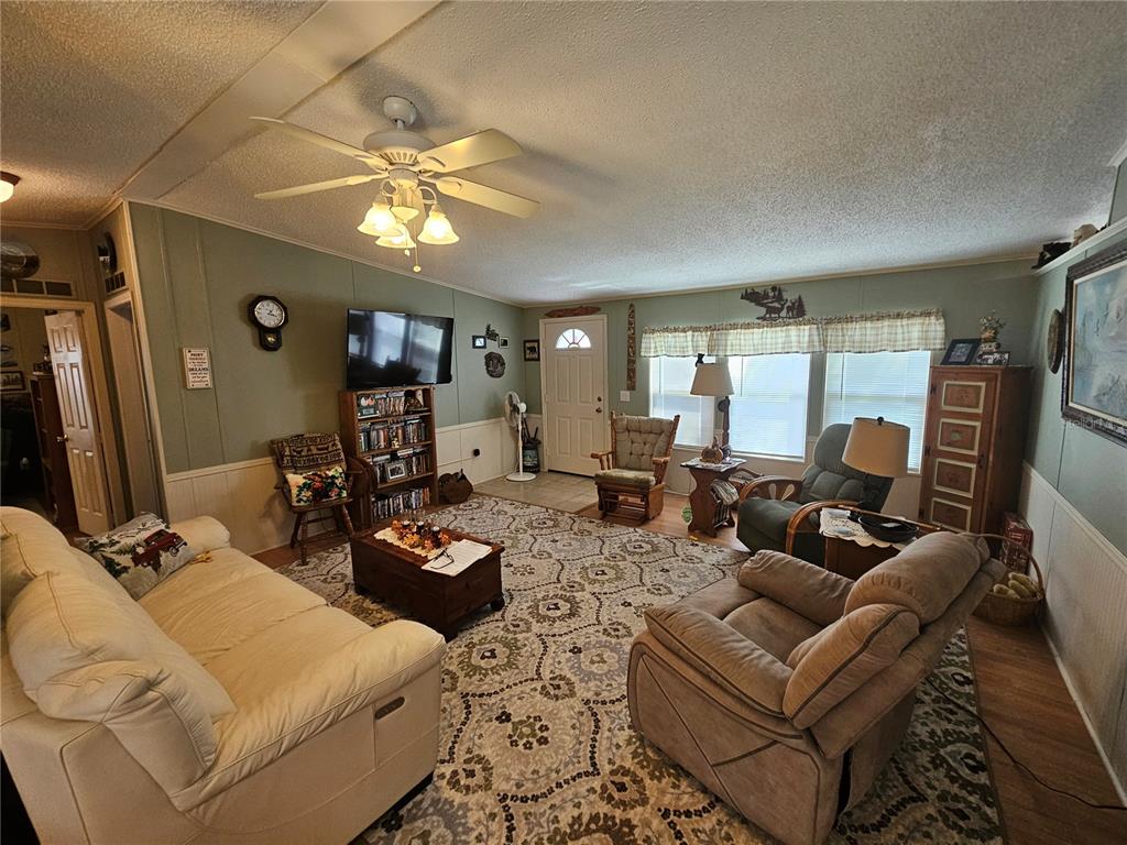 7050 Southeast Co Road 337 Morriston, FL 32668 - Photo 28 of 67 a living room with furniture a large window with rug