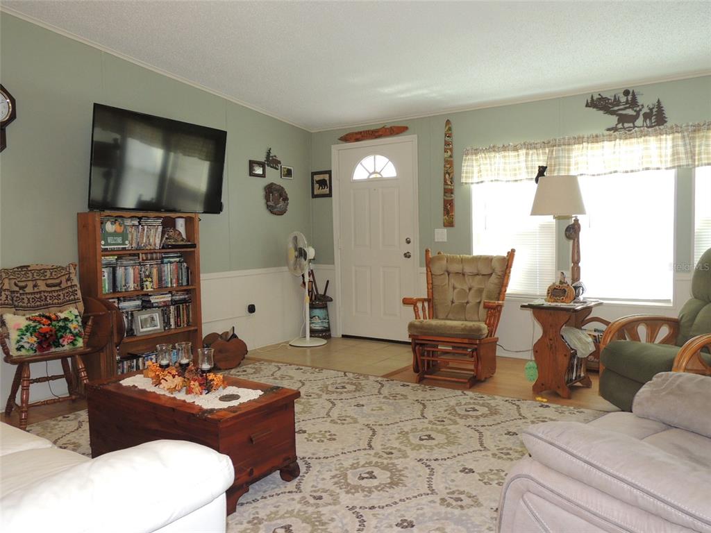 7050 Southeast Co Road 337 Morriston, FL 32668 - Photo 29 of 67 a living room with furniture and a flat screen tv