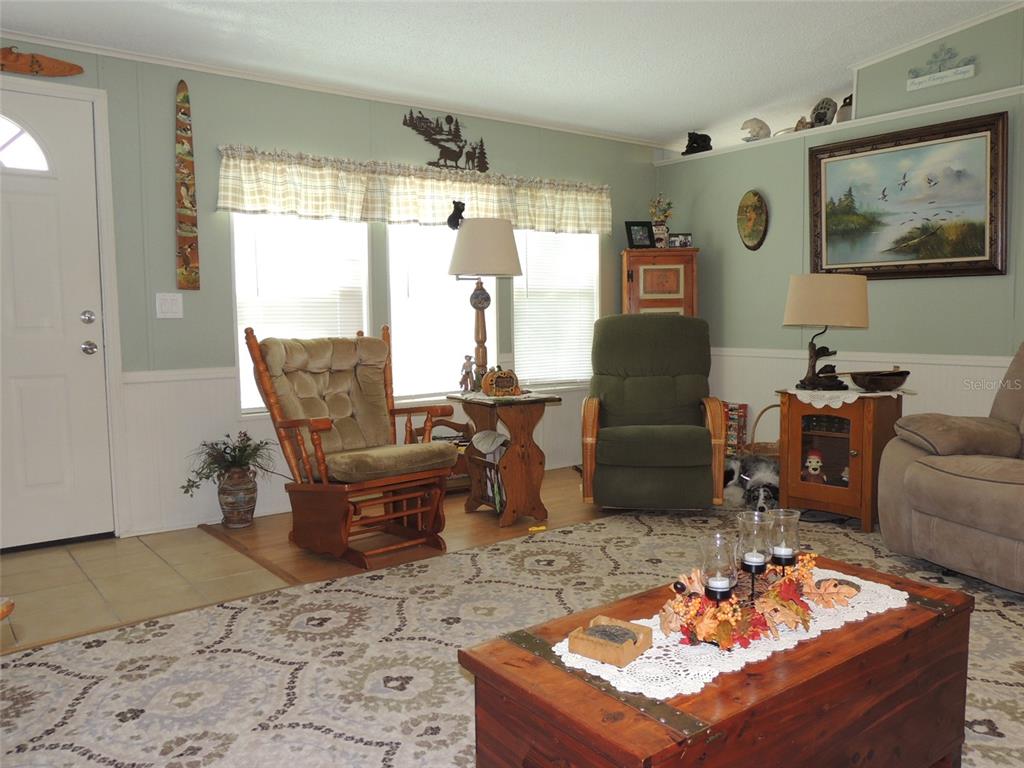 7050 Southeast Co Road 337 Morriston, FL 32668 - Photo 30 of 67 a living room with furniture and a window