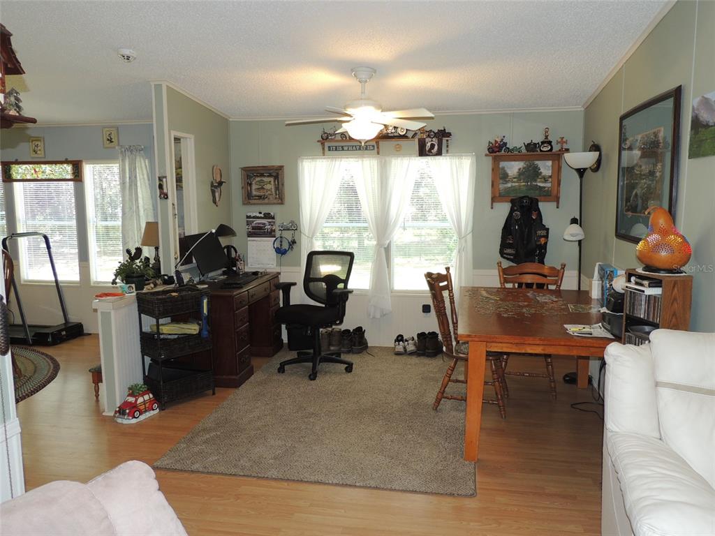 7050 Southeast Co Road 337 Morriston, FL 32668 - Photo 32 of 67 a view of a livingroom with workspace and a window