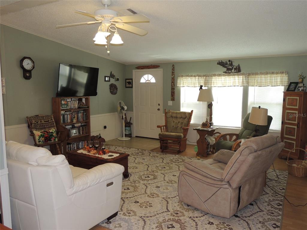 7050 Southeast Co Road 337 Morriston, FL 32668 - Photo 34 of 67 a living room with furniture and a flat screen tv