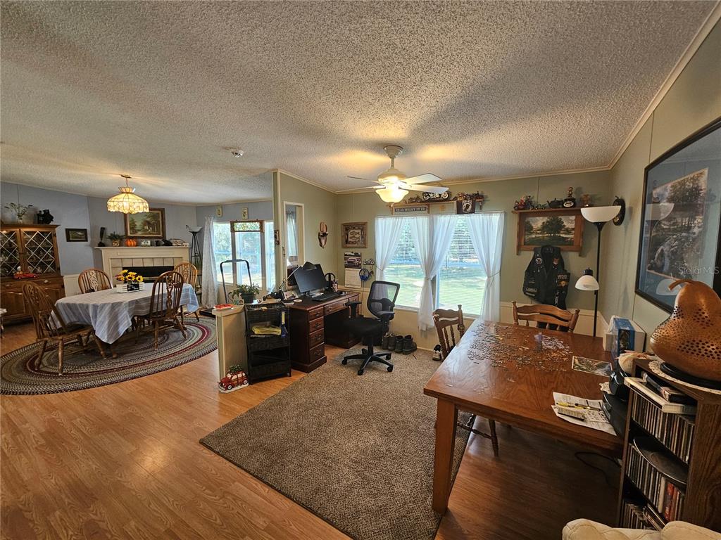7050 Southeast Co Road 337 Morriston, FL 32668 - Photo 41 of 67 a living room with furniture a wooden floor and a large window