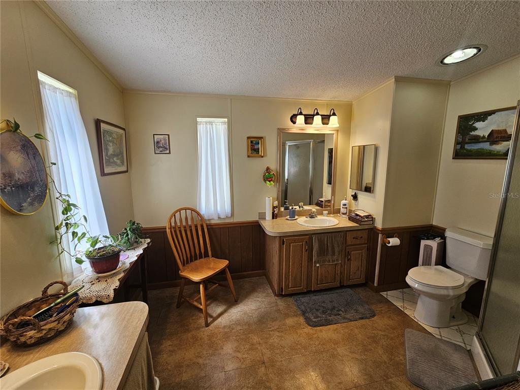 7050 Southeast Co Road 337 Morriston, FL 32668 - Photo 53 of 67 a bathroom with a sink and a mirror