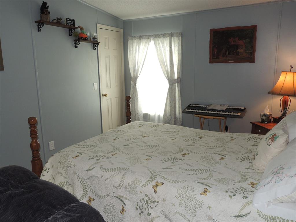 7050 Southeast Co Road 337 Morriston, FL 32668 - Photo 57 of 67 a bedroom with a bed and a window