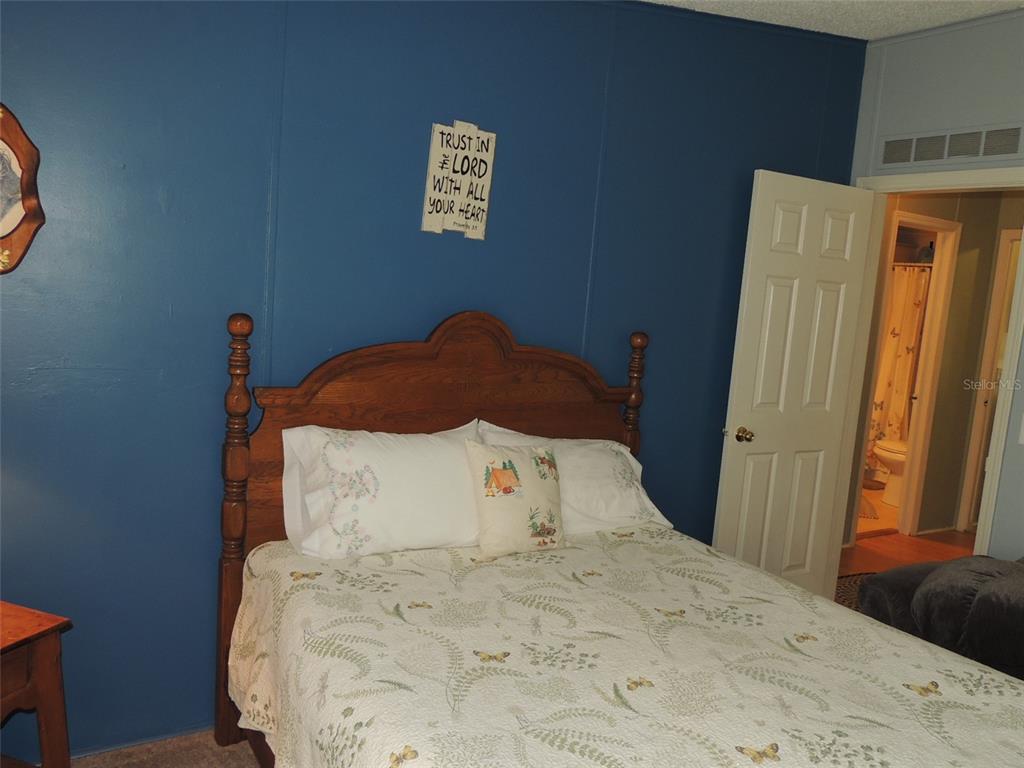 7050 Southeast Co Road 337 Morriston, FL 32668 - Photo 58 of 67 a bedroom with a bed and a window