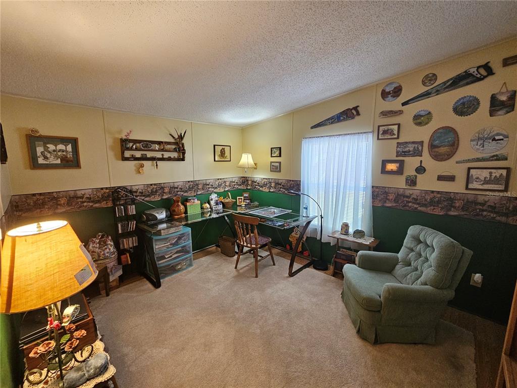 7050 Southeast Co Road 337 Morriston, FL 32668 - Photo 59 of 67 a living room with furniture and a flat screen tv with wooden floor