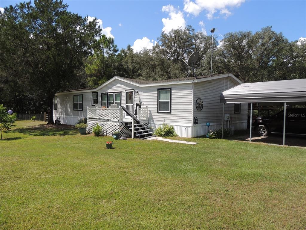 7050 Southeast Co Road 337 Morriston, FL 32668 - Photo 6 of 67 a view of a house with a yard porch and sitting area