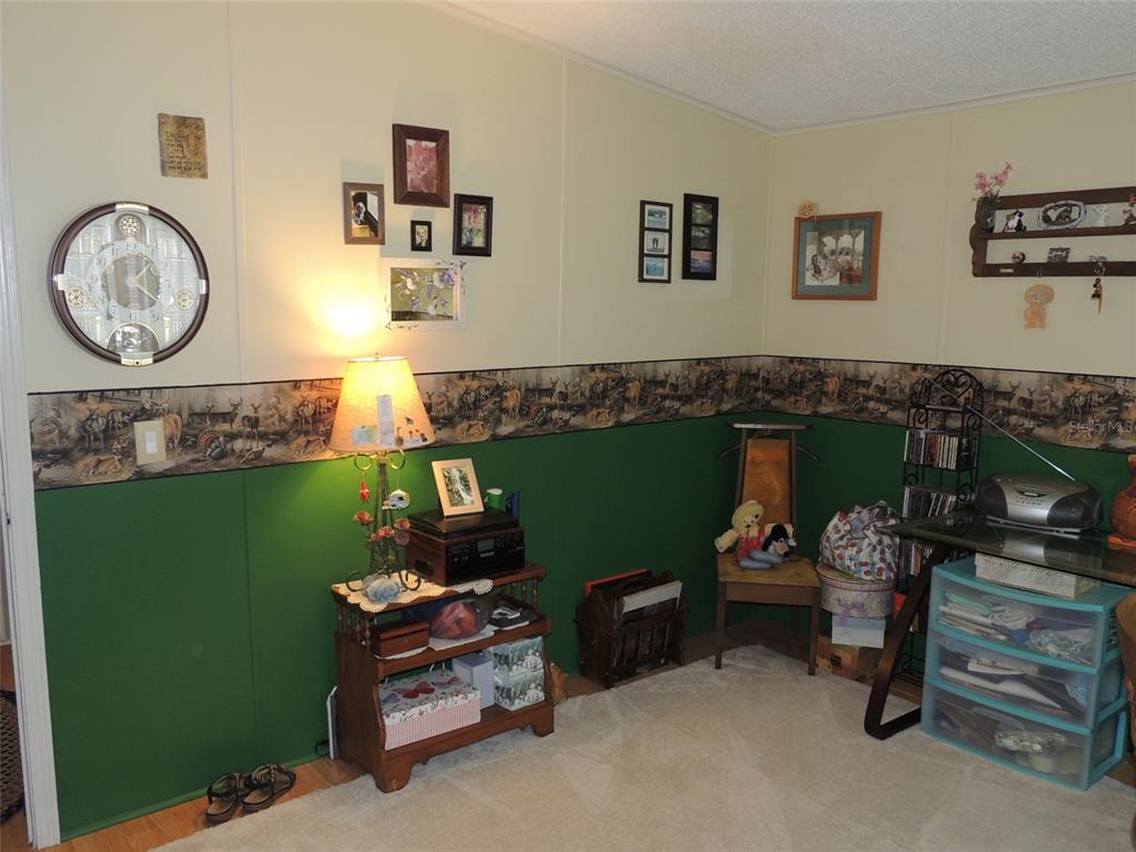 7050 Southeast Co Road 337 Morriston, FL 32668 - Photo 61 of 67 a living room with furniture and a fireplace
