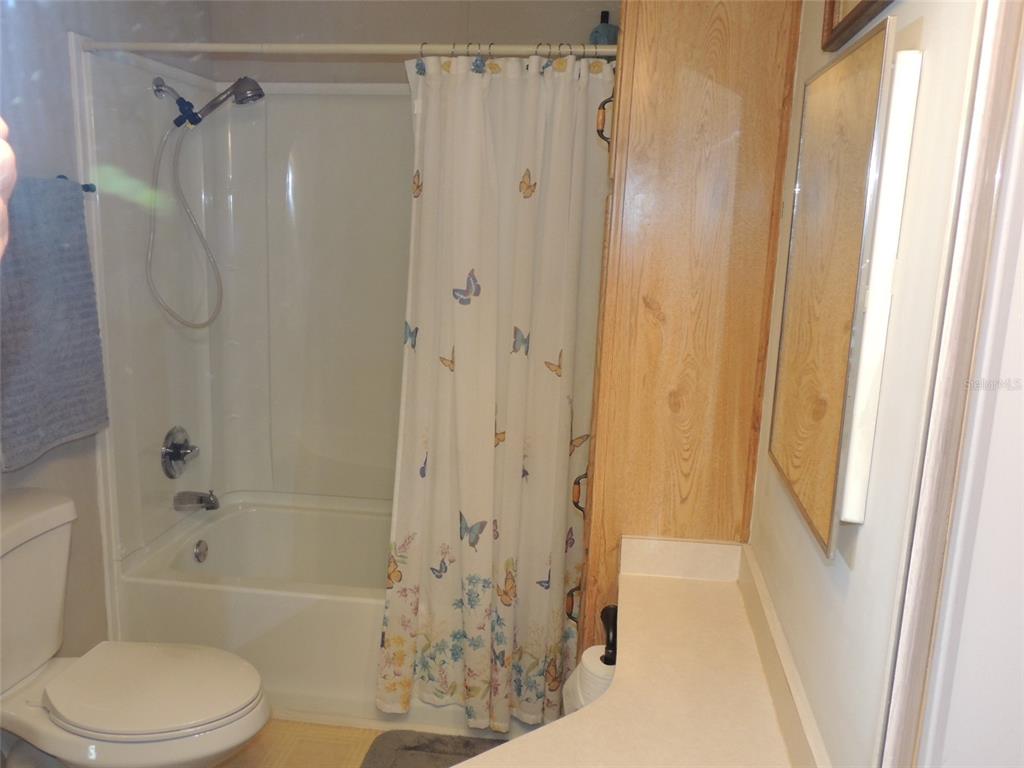 7050 Southeast Co Road 337 Morriston, FL 32668 - Photo 66 of 67 a bathroom with a shower a toilet and a glass door shower