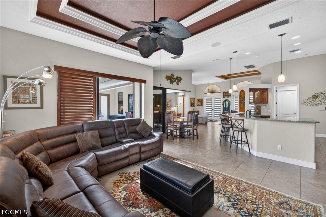 6109 Calusa Rdg Trail Bokeelia, FL 33922 - Photo 24 of 48 a living room with furniture kitchen view and a chandelier