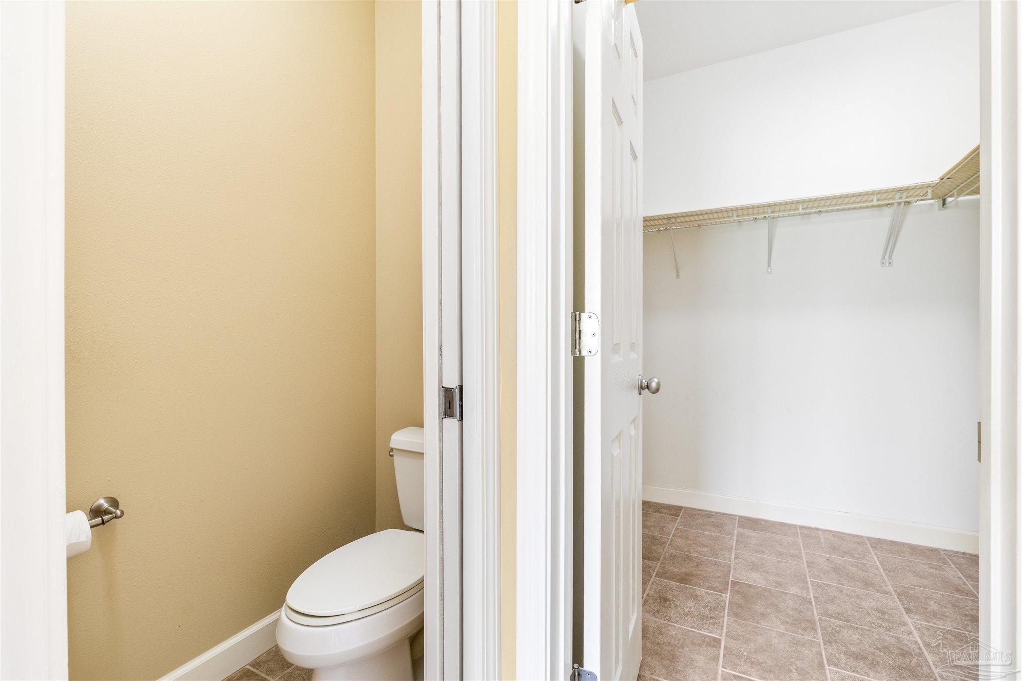 26064 Chatelaine Road Elberta, AL 36530 - Photo 26 of 52 a bathroom with a granite countertop shower and a toilet