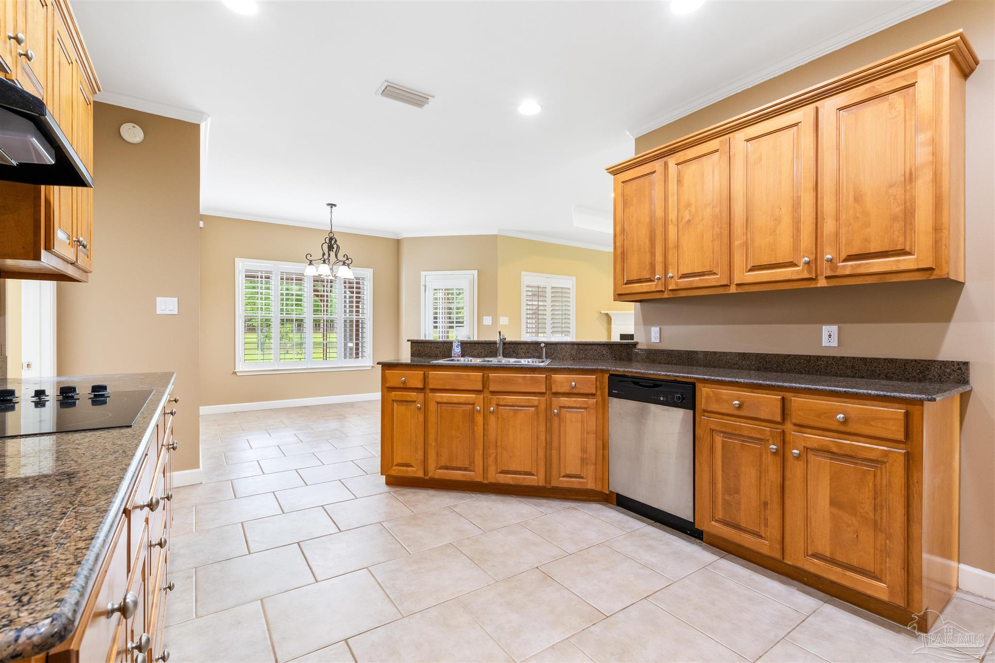 26064 Chatelaine Road Elberta, AL 36530 - Photo 5 of 52 a large kitchen with granite countertop a sink a stove cabinets and counter space