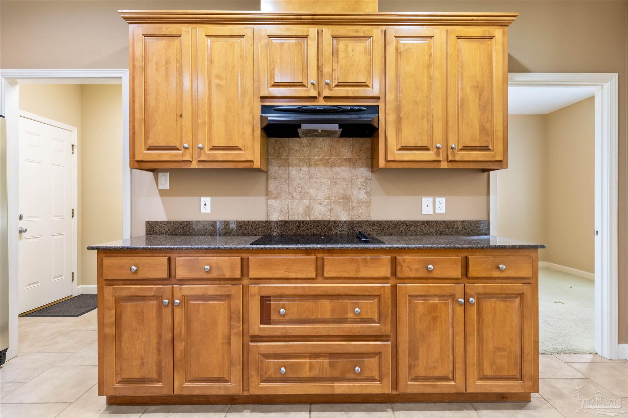 26064 Chatelaine Road Elberta, AL 36530 - Photo 6 of 52 a kitchen with granite countertop white cabinets and stainless steel appliances