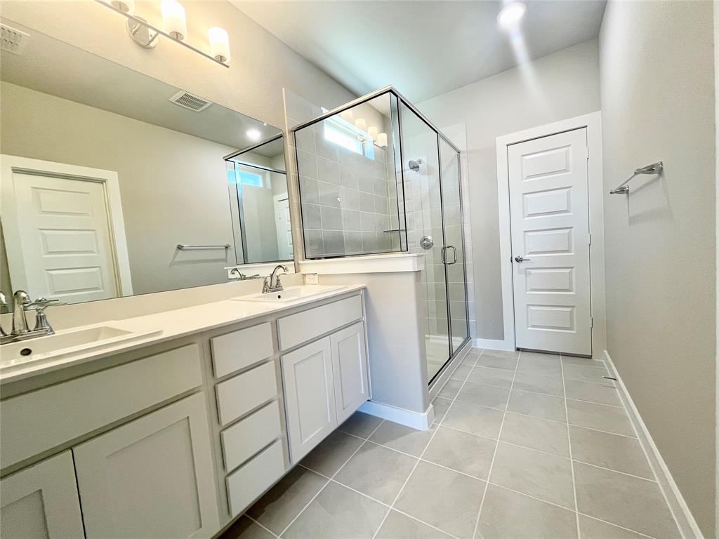 1904 Edgewater Street Celina, TX 75009 - Photo 7 of 11 a spacious bathroom with a mirror sink and shower