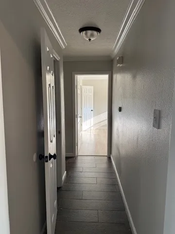 a view of a hallway with the wooden floor