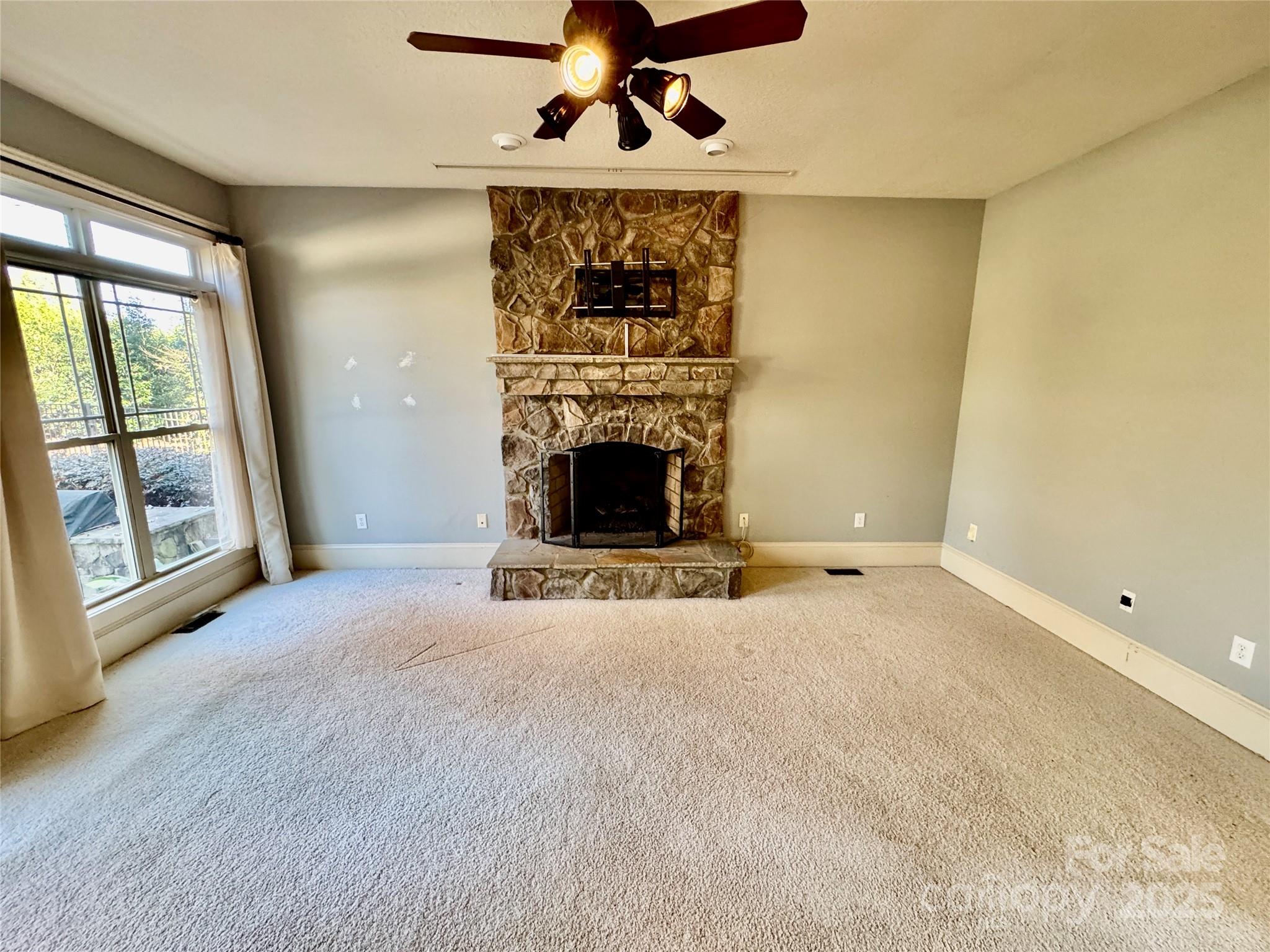 600 Baron Road Waxhaw, NC 28173 - Photo 16 of 42 a view of an empty room with a fireplace and a window