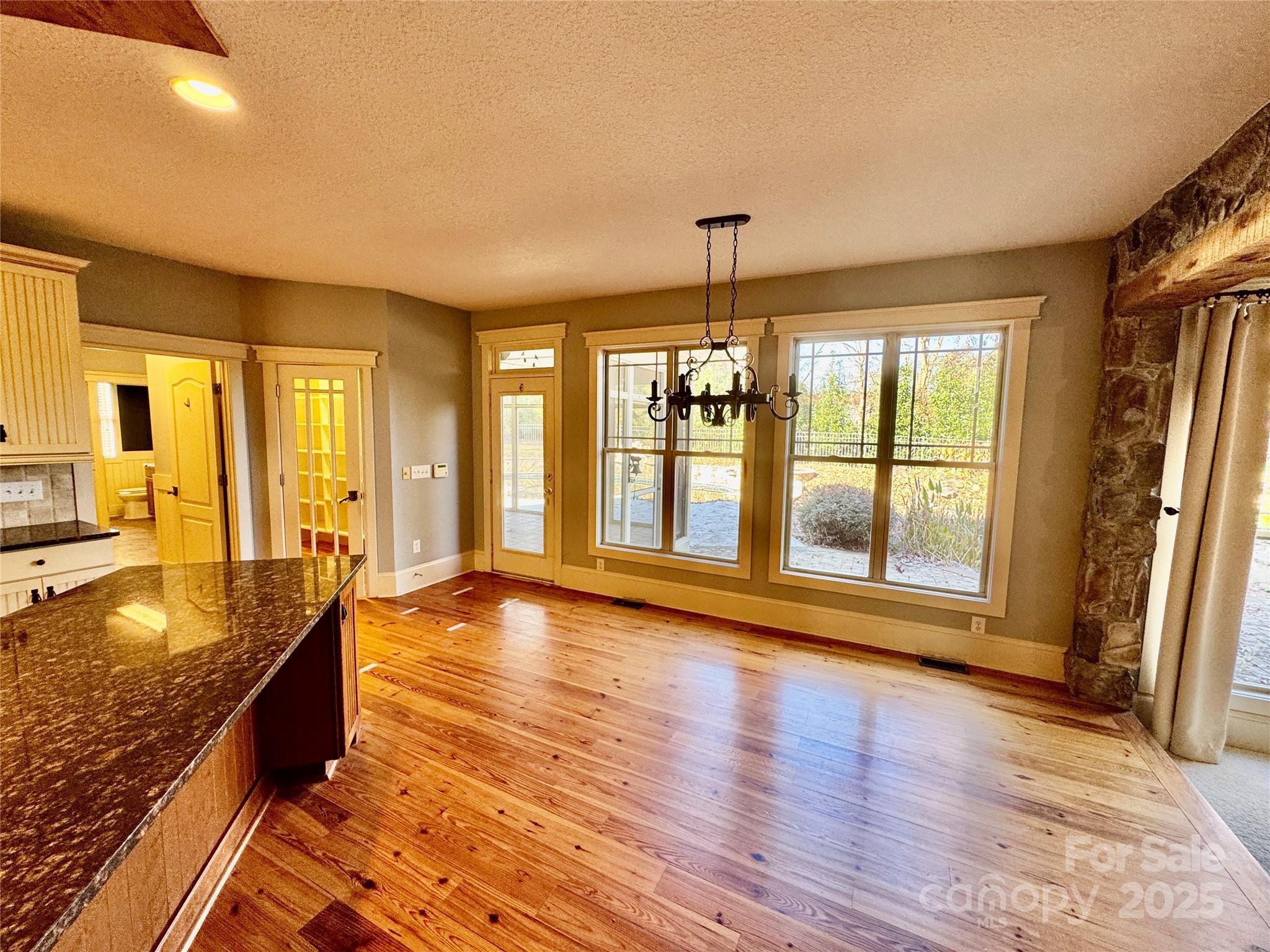 600 Baron Road Waxhaw, NC 28173 - Photo 17 of 42 a view of an empty room with window and wooden floor