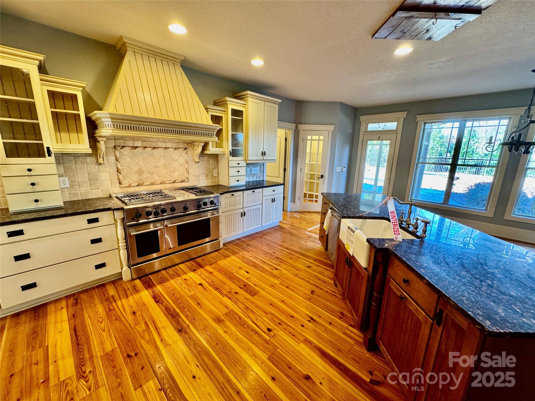 600 Baron Road Waxhaw, NC 28173 - Photo 19 of 42 a kitchen with stainless steel appliances granite countertop a stove and a wooden floors