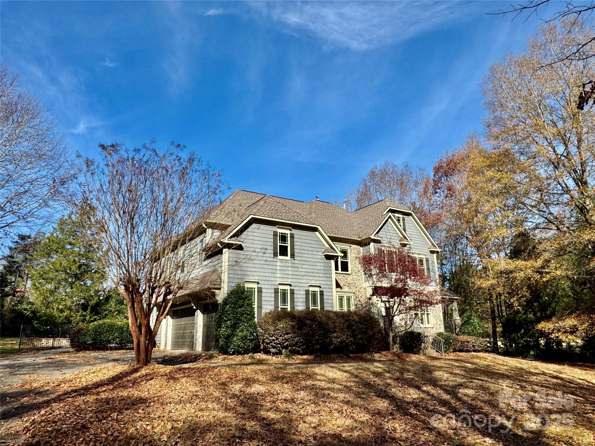 600 Baron Road Waxhaw, NC 28173 - Photo 3 of 42 a view of a large white house with a big yard and large trees