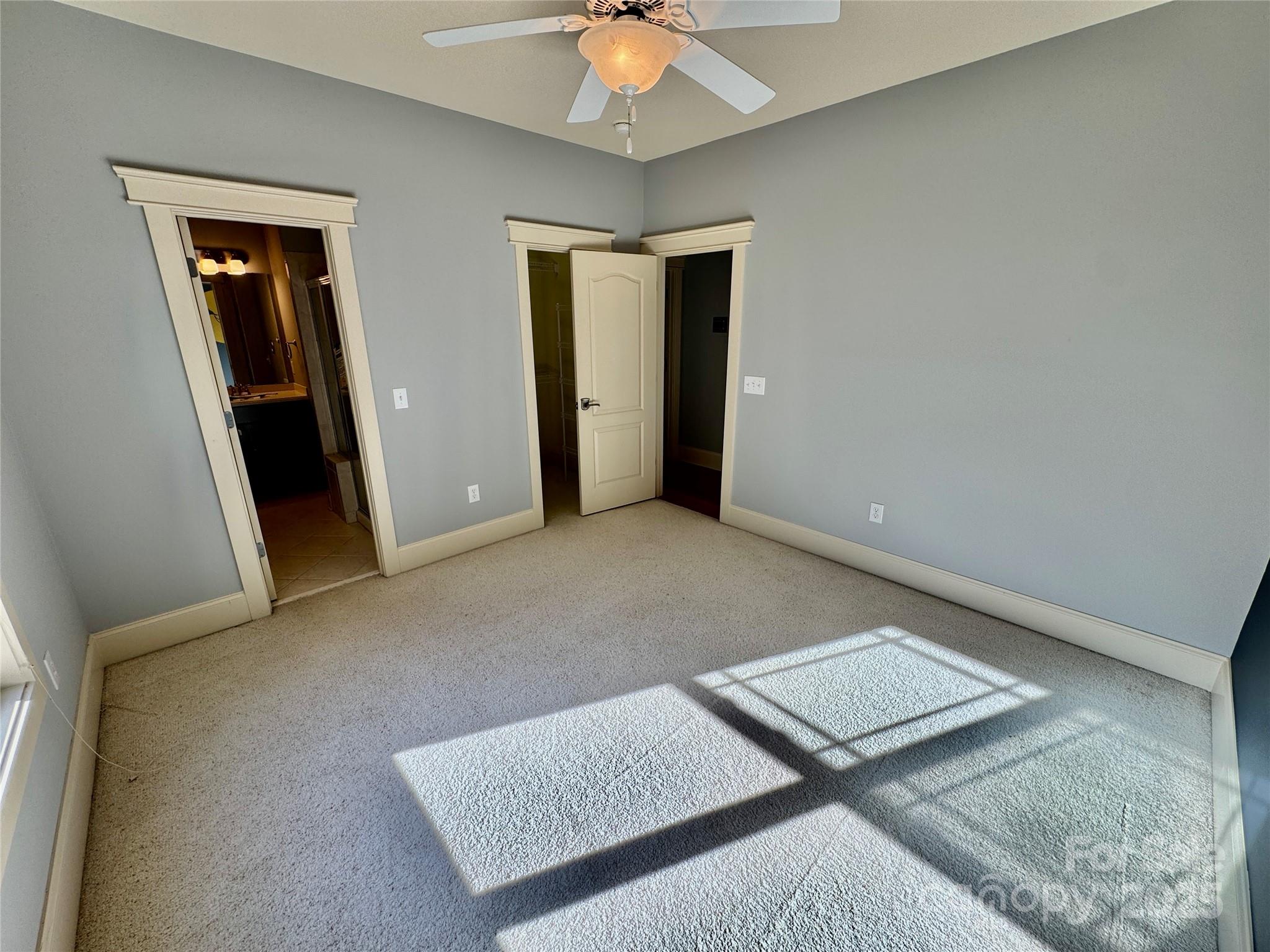 600 Baron Road Waxhaw, NC 28173 - Photo 33 of 42 an empty room with closet and chandelier fan