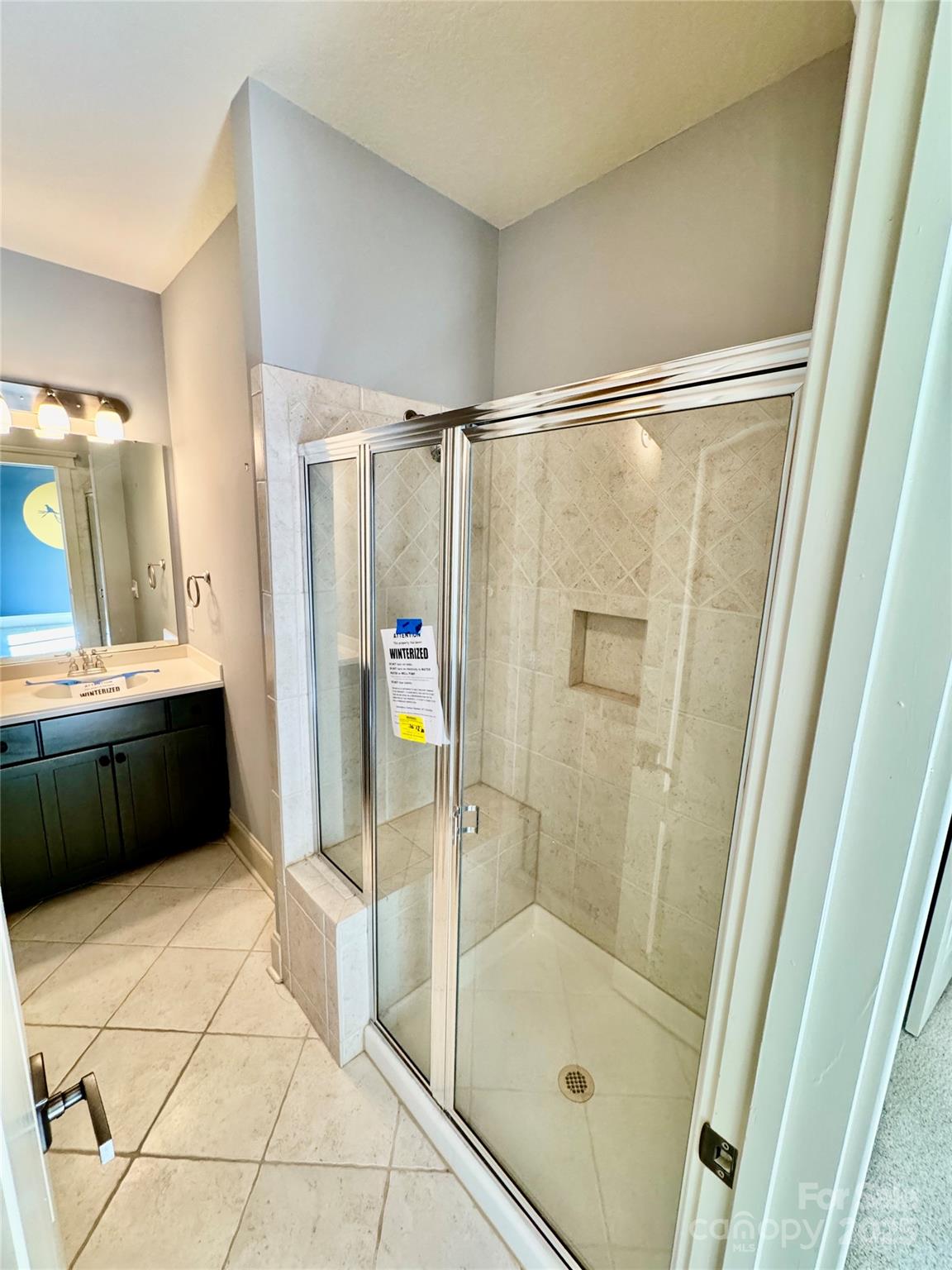 600 Baron Road Waxhaw, NC 28173 - Photo 34 of 42 a bathroom with a glass shower door and a sink