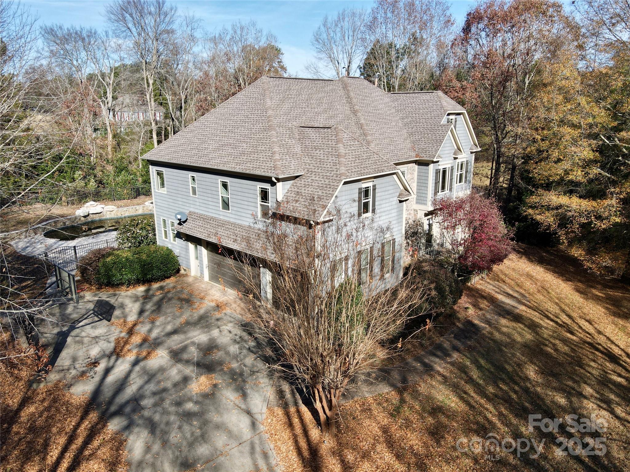 600 Baron Road Waxhaw, NC 28173 - Photo 4 of 42 a aerial view of a house with a yard and large trees