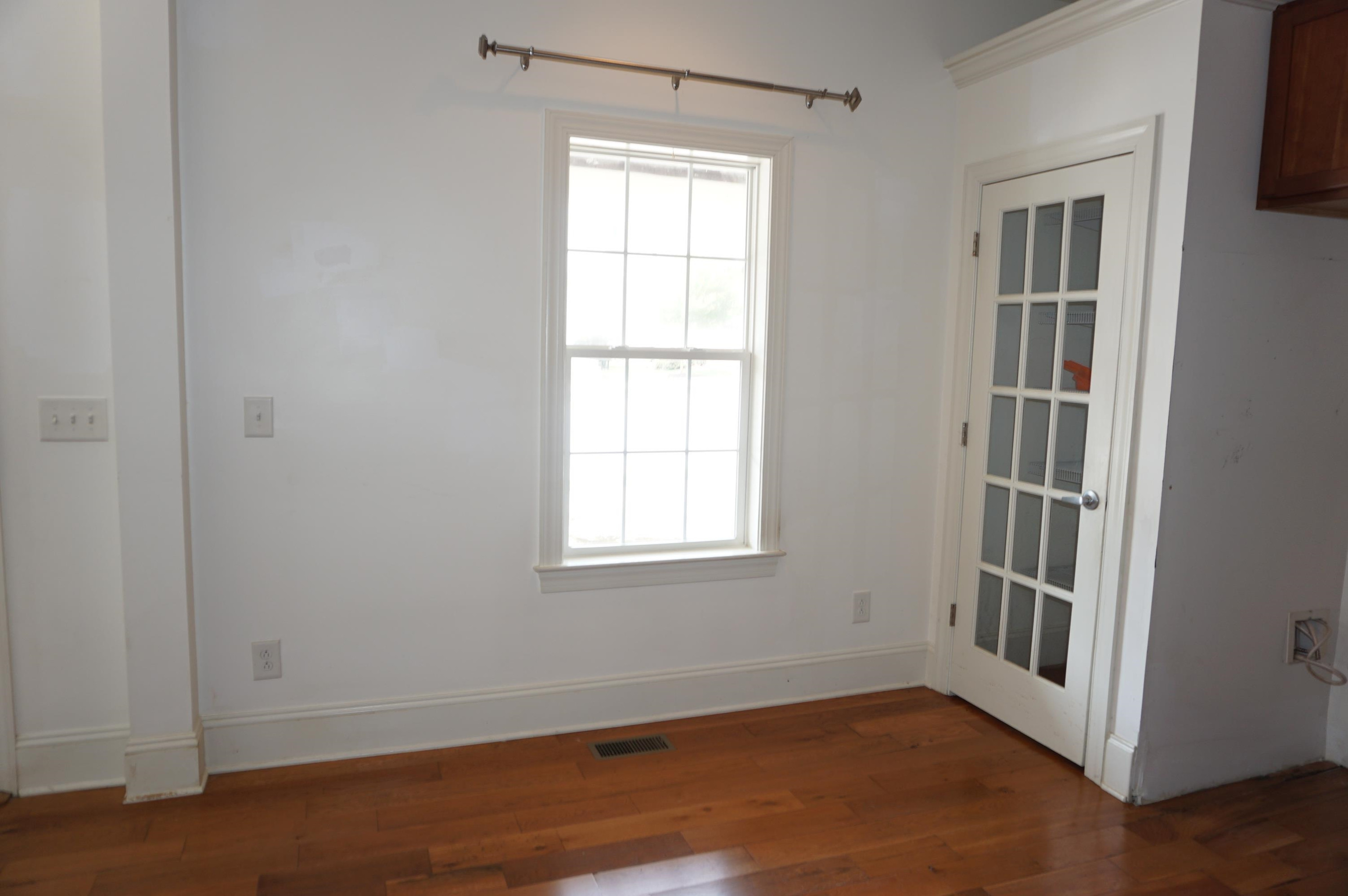 523 East Edenton Street Raleigh, NC 27601 - Photo 12 of 53 an empty room with wooden floor and windows