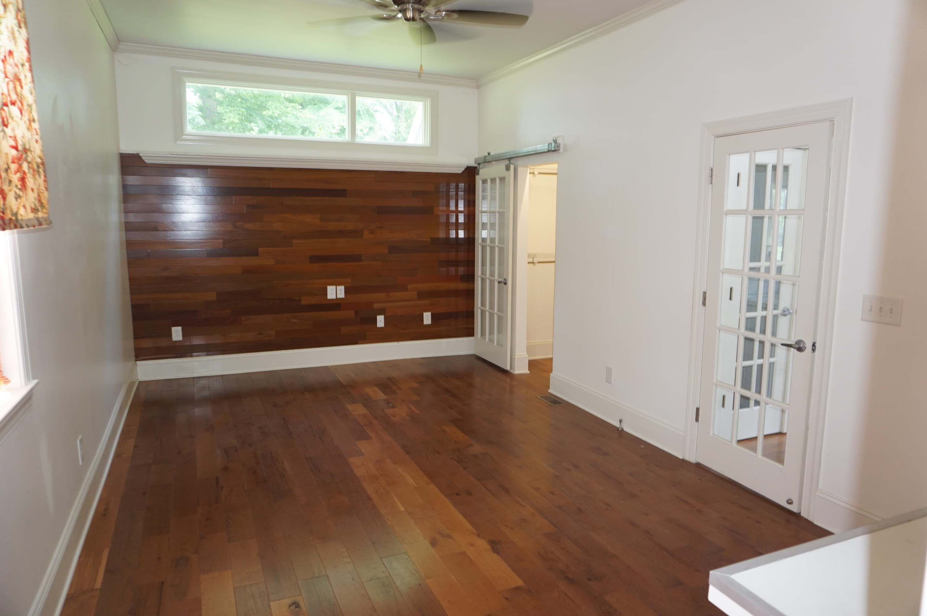 523 East Edenton Street Raleigh, NC 27601 - Photo 19 of 53 an empty room with wooden floor mirror and windows