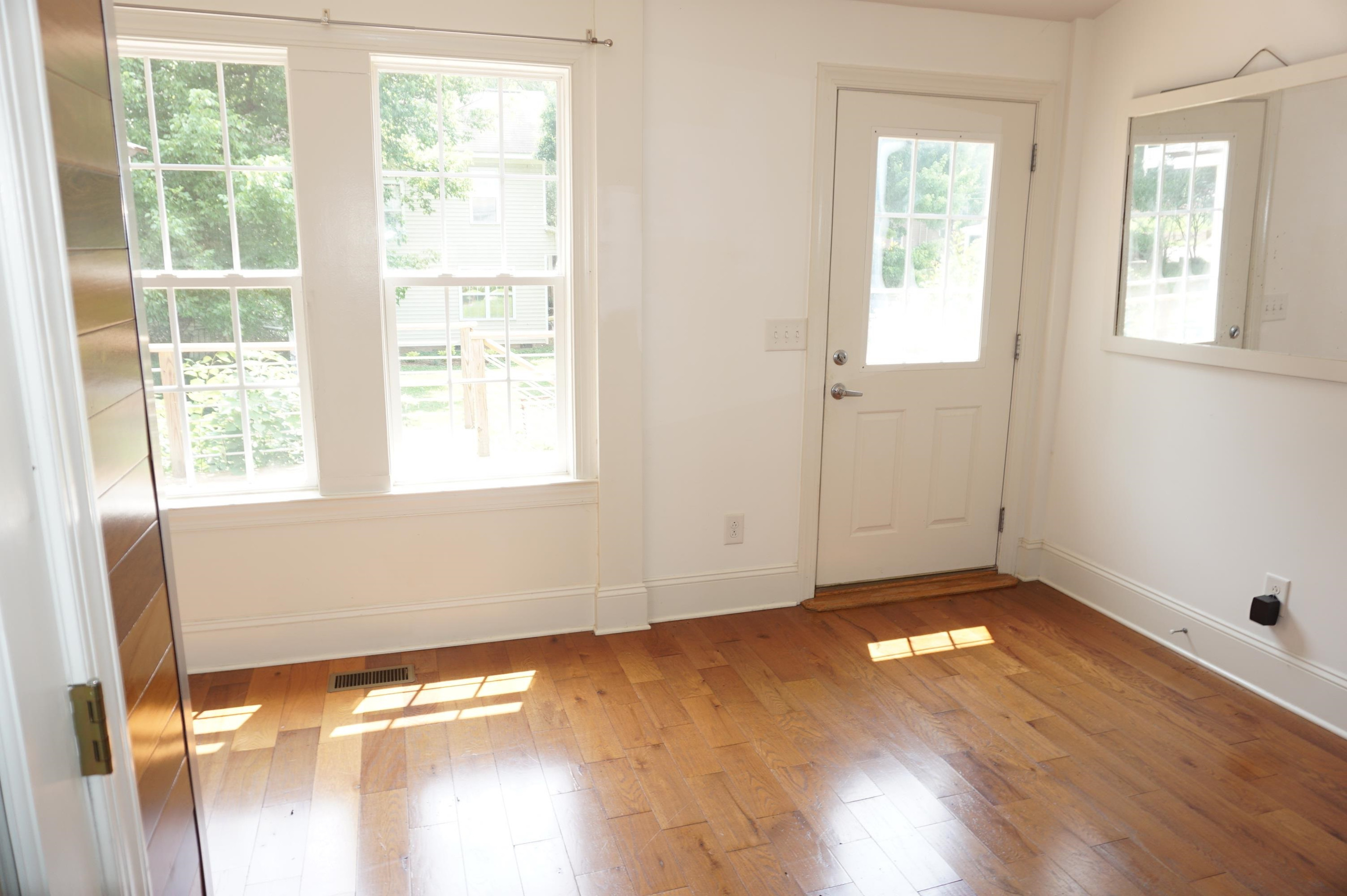 523 East Edenton Street Raleigh, NC 27601 - Photo 32 of 53 a view of an empty room with wooden floor and a window