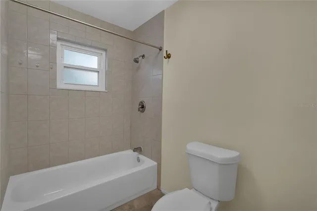 a bathroom with a toilet and bathtub