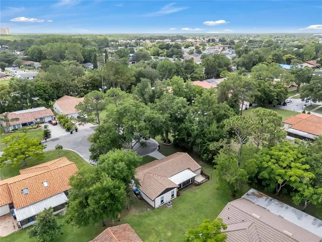 an aerial view of a house with a yard