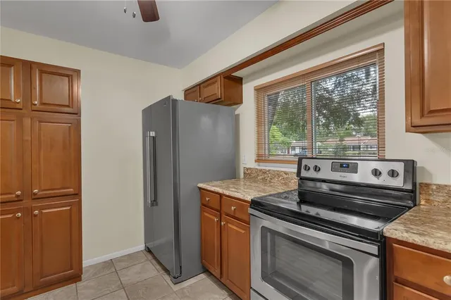 a kitchen with stainless steel appliances granite countertop a refrigerator and a stove