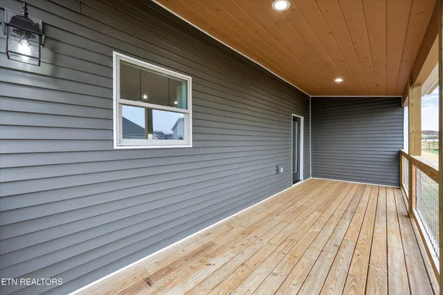 a view of balcony with a floor to ceiling window next to a yard