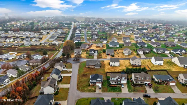 an aerial view of residential houses with outdoor space and swimming pool