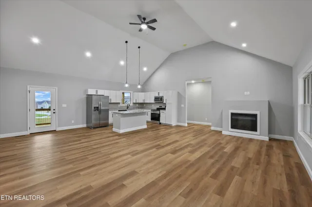 a view of a kitchen with a sink and a fireplace