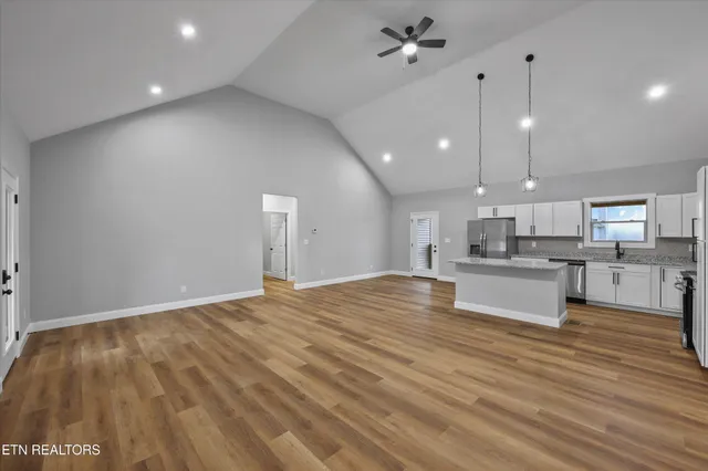 a kitchen with stainless steel appliances granite countertop a stove top oven a sink and dishwasher