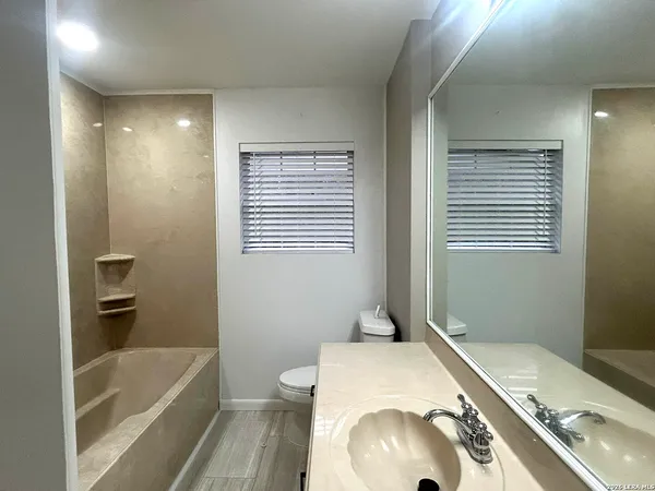 a bathroom with a sink a toilet and bathtub