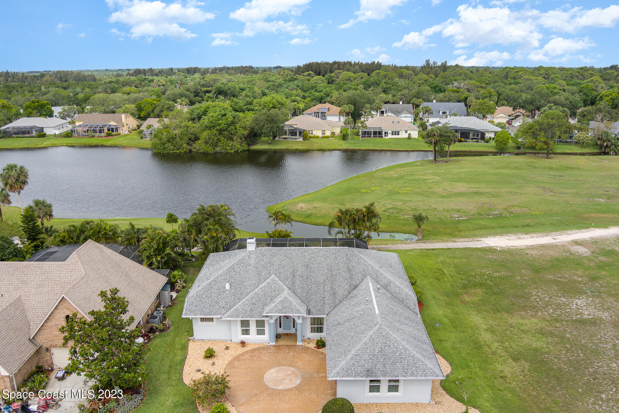 an aerial view of a house with a lake view