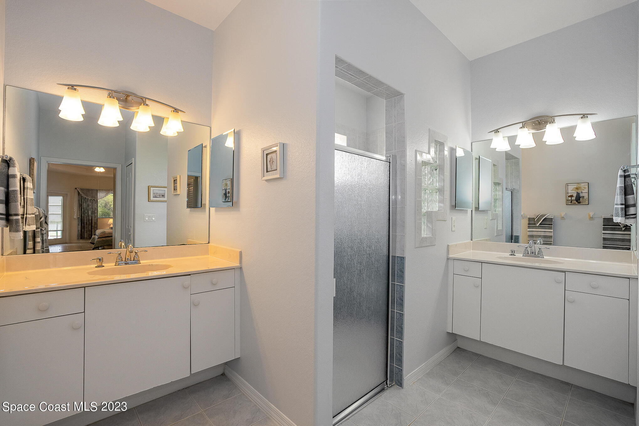 4105 Sand Ridge Drive Merritt Island, FL 32953 - Photo 15 of 31 a bathroom with a double vanity sink and mirror
